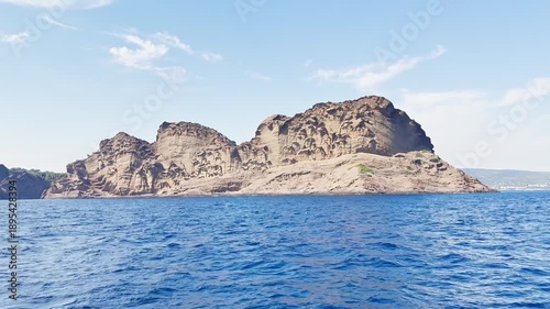 Calanque de Figuerolles seen from the sea during a boat trip, showing dramatic limestone cliffs, turquoise Mediterranean water on the French Riviera, Cote d’Azur, near La Ciotat, France.