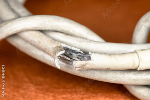 Worn out electrical cable. Damaged charging cable in macro