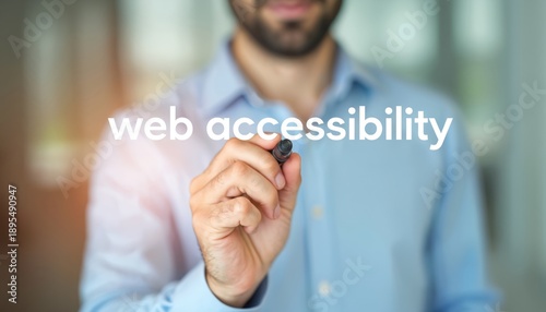 Man writes web accessibility text on transparent screen. Focus on inclusivity and user experience for all individuals interacting with digital content and platforms.
