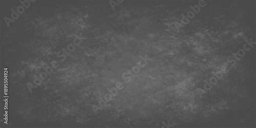 A dark and textured black and white grunge background featuring a vintage grey stone wall pattern with a dirty concrete surface and an old blank blackboard design for a moody wallpaper backdrop