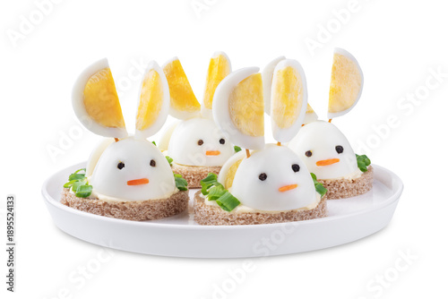 Bread with mayonnaise sauce and boiled egg in the form of rabbit in a plate on a white isolated background