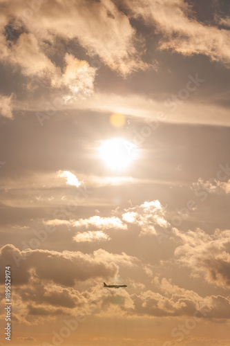 Bright sun shining through dramatic clouds in the sky