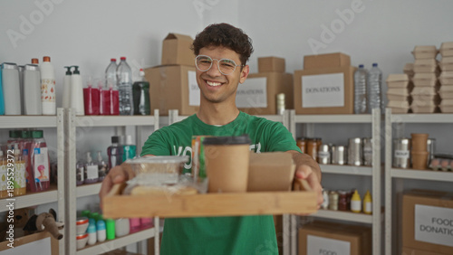 Cuadro en lienzo Man holds a tray of meals and a coffee cup while standing in a donation center building distributing donations; compassion community support