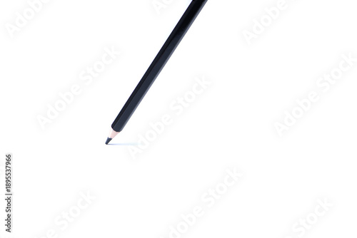 Single black wooden pencil with sharpened tip isolated on white background, minimal composition with copy space. Concept of creativity, writing, drawing, and education.