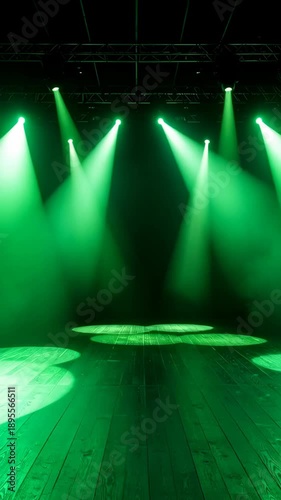 Empty concert stage illuminated by bright green spotlights and atmospheric fog