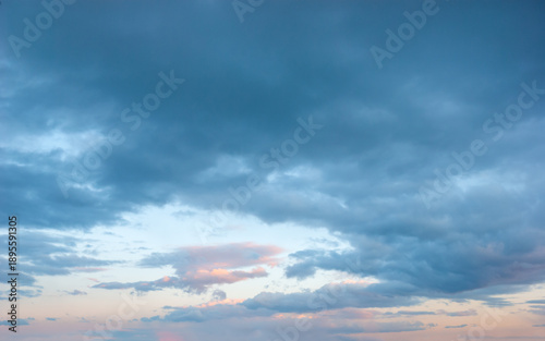 Beautiful sky, golden clouds in a blue sky at sunset create a natural backdrop and a wonderful evening atmosphere.