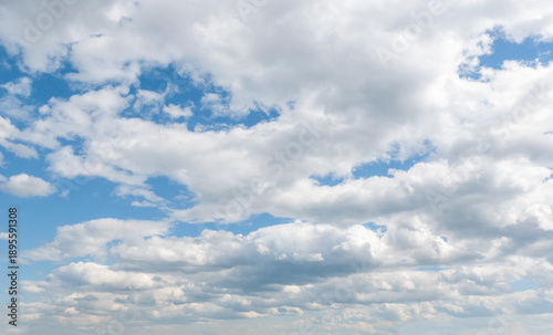 Beautiful sky, white fluffy clouds, multilayered and varied, sun and blue sky. A majestic view in summer.