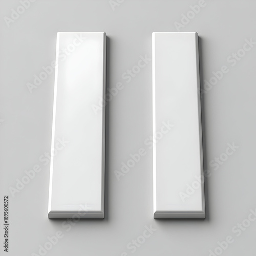 Two White Rectangular Objects on Gray Background.