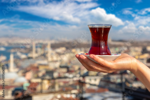 Female hand holds Turkish tea cup