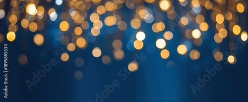 A blurred background featuring soft, glowing lights in warm tones against a deep blue backdrop, creating a dreamy and festive atmosphere.
