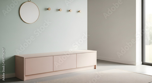  Scandinavian style minimalist hallway interior featuring a long dusty pink sideboard cabinet, mint green wall with circular mirror and gold coat hooks, grey floor and natural morning sunlight.