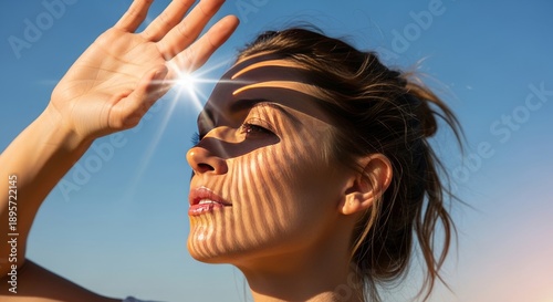 Woman shielding eyes from bright sun with striped shadow pattern on face