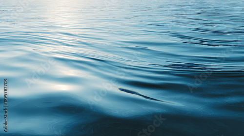 A serene and peaceful body of water with gentle waves and sunlight reflection