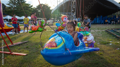 Obraz na plátně Little girl enjoy outdoor amusement city park festival
