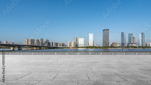 Modern City Skyline with River and Bridge