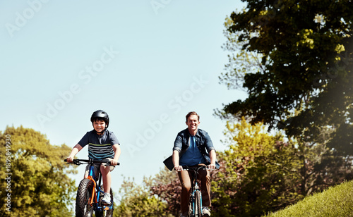 Happy family, son and riding bicycle with dad for bonding, childhood or physical activity together. Father, child or cycling with kid on road for travel, learning or development in neighborhood