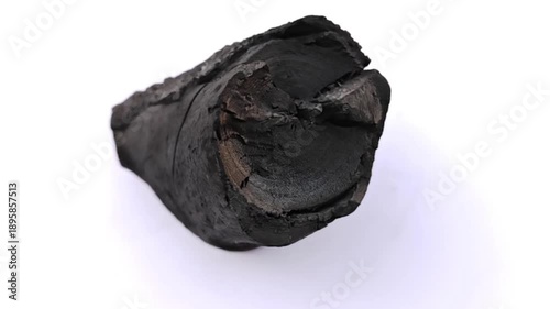The video shows the production of charcoal from tamarind wood.	