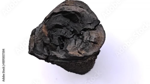 The video shows the production of charcoal from tamarind wood.	