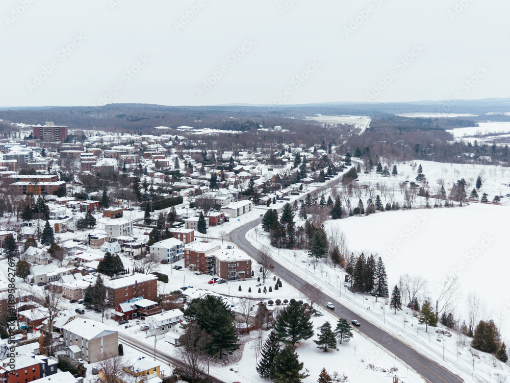 Obraz premium Aerial winter view of Granby city with snowy streets, church buildings and urban landscape, Quebec, Canada. g