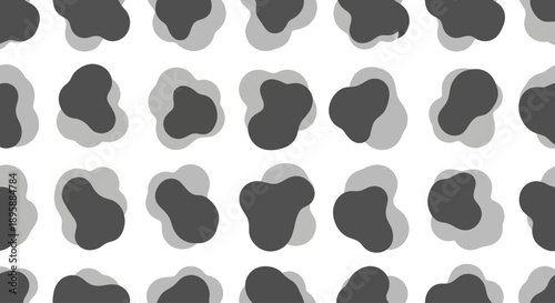 Abstract organic shapes repeating pattern, dark grey and light grey amorphous blobs.