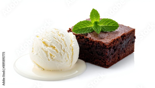 Decadent dessert featuring a rich chocolate brownie with vanilla ice cream and fresh mint on a clean, white surface