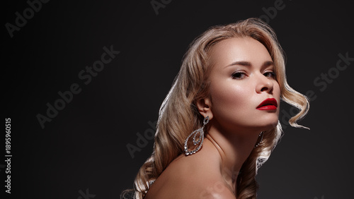 Glamorous Model With Statement Earrings, Red Lipstick, Dramatic Side Lighting, Moody Black Backdrop, Metallic Jewelry Sparkle, Poised Expression, Couture Styling, Red Carpet Glamour, Cinematic