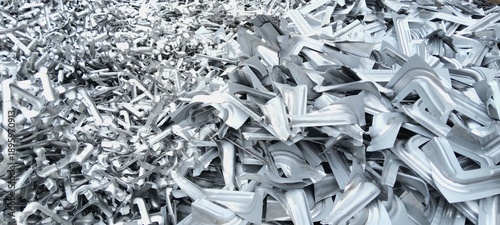 Fotografie Pile of shiny aluminum scrap metal parts for recycling in industrial yard