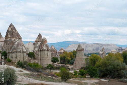 Wide landscape view of Love Valley Trail in Goreme, Cappadocia, Turkey Türkiye, featuring distinctive fairy chimney rock formations under a clear blue