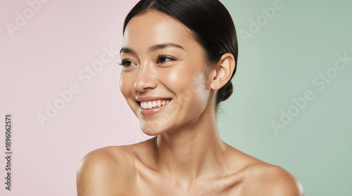 Stunning Asian woman with glowing glass skin and a joyful expression. Close-up beauty portrait for premium skincare, natural makeup, and wellness branding. Minimalist aesthetic, soft lighting.