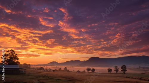 Dramatic Sunset Over Rolling Hills with Misty Valley