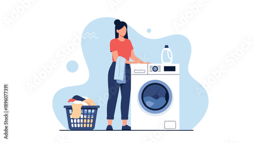 Young woman putting laundry into a modern front loading washing machine with a full basket of clothes on the side.