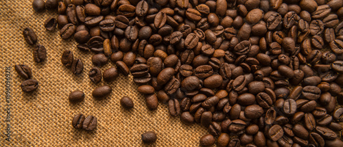 Background image: Roasted coffee beans on a burlap cloth.
