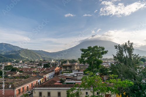 Elevated view across Antigua with terracotta rooftops stretching toward the iconic Volcán de Agua
