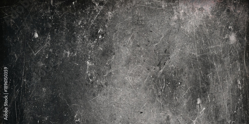 Vintage black grunge background with heavy white scratches a distressed chalkboard or worn metal look, perfect for creators looking to add grit.