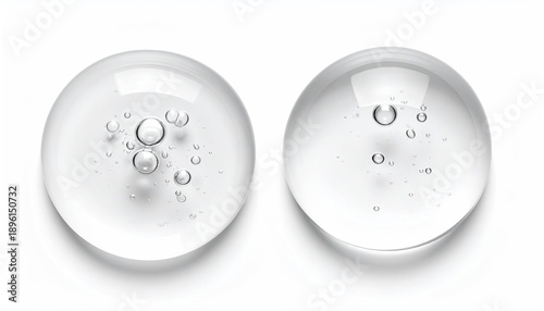 Two clear drops with bubbles on white