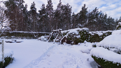 A bench in the park covered with snow in winter. 