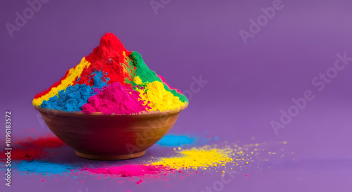 Vibrant colors of holi powder in a bowl on purple background