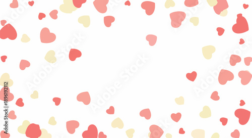 Close-up of colorful red and yellow heart-shaped confetti on a white background with a shallow depth of field.