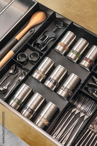 Cutlery set neatly organized in kitchen drawer, forks, knives and spoons in storage tray