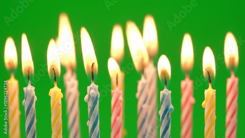 Lit candles on green backdrop festive flames and celebratory visuals
