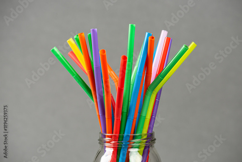 Obraz na plátně Colorful flexible plastic drinking straws arranged in glass jar.