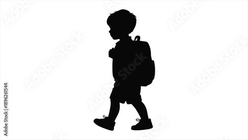 Young boy with backpack walking alone to school on a clear day outside viewed from side