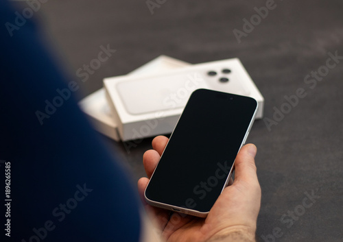 Germany - September 20, 2025. Man holding the newly released silver Apple iPhone 17pro max 