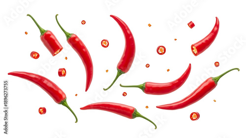 Vibrant red chili peppers and slices flying in air isolated on transparent background
