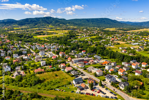 Aerial panoramic view of disperse housing of residential district of Andrychow city with Beskidy Mountains in background in Lesser Poland