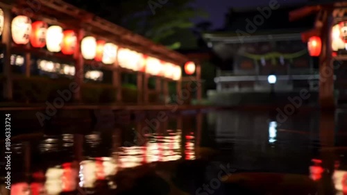 Evening scene of illuminated lanterns by water traditional architecture