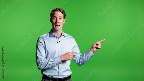 Man in light blue shirt points to the right against a green background
