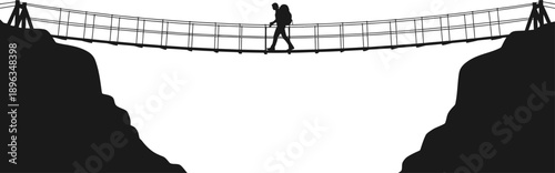 A person walking across a suspension bridge between two cliffs