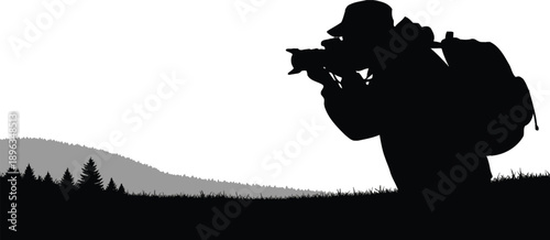 Silhouette of a person taking a photograph in a scenic landscape