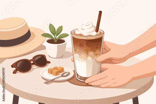 Hand placing iced coffee with whipped cream on outdoor table for summer relaxation